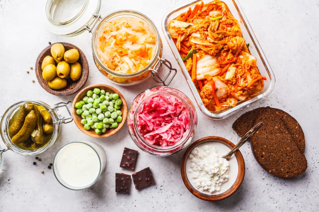 Fermented foods rich in probiotics like yogurt, kimchi, sauerkraut, and pickles