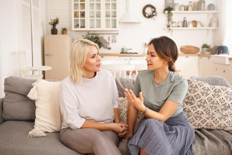 Caregiver engaging in a heartfelt conversation with a friend, emphasizing the importance of seeking support