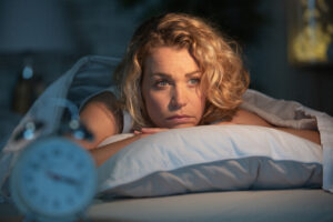 Woman lying awake at night with anxiety-driven insomnia in her Northern Virginia home